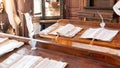 Catholic monks are literacy teachers in a medieval school. School in a Catholic Jesuit monastery. Old manuscripts and paper with a Royalty Free Stock Photo