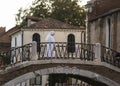 Catholic nun in traditional white habit crossing over a bridge in Venice, Italy Royalty Free Stock Photo