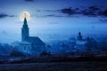 Catholic and orthodox churches at foggy night Royalty Free Stock Photo