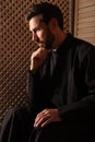 Catholic priest in cassock listening to confession Royalty Free Stock Photo