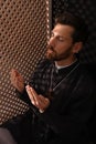 Catholic priest in cassock praying to God in confessional booth Royalty Free Stock Photo