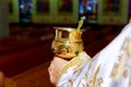 catholic priest with chalice cup during consecration ceremony