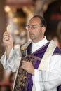 Catholic priest during communion in worship