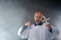 Catholic priest exorcist in white surplice and black shirt