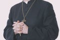 Catholic priest holds rosary