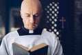 Catholic priest reading bible in church Royalty Free Stock Photo