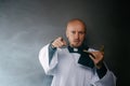 Catholic priest in white surplice and black shirt with cleric collar reading bible