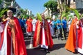 Catholic priests and worshipers walk together during the Palm Sunday procession