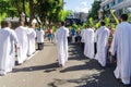 Catholic priests and worshipers walk together during the Palm Sunday procession