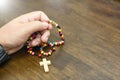 Catholic rosary beads in hand Royalty Free Stock Photo