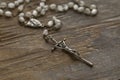 Catholic rosary at an old wooden table