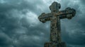 Catholic stone cross standing out prominently against dynamic gray clouds in motion