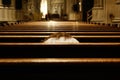 Catholic woman alone praying prostrate inside a Christian temple