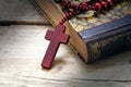 Catholic wooden rosary beads with cross on an old book on rustic Royalty Free Stock Photo