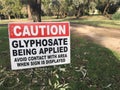 Cation Glyphosate being applied. Outdoor sign on city park path Royalty Free Stock Photo