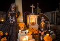 Mexican Catrina and Catrin at a cementery