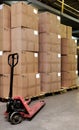 Catron boxes and pallet truck in warehouse Royalty Free Stock Photo