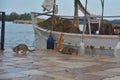 cats on the shore near a fishing boat waiting for fresh fish for breakfast, Greece