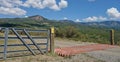 Cattle guard and fence in Colorado mountains. Royalty Free Stock Photo