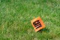 Orange flag with letters CATV on a grass background