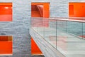 Catwalk modern building with several floors and orange painted passages