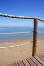 Catwalk on wood rope railing on sea beach Royalty Free Stock Photo