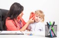 Cauacsian doctor otolaryngologist examines the ear of a little girl who has pain in her ear. The concept of otitis media