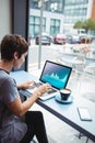 Caucacian businesswoman sitting at desk using laptop with statistical data on screen Royalty Free Stock Photo