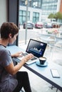 Caucacian businesswoman sitting at desk using laptop with statistical data on screen Royalty Free Stock Photo