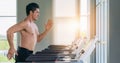 Athletic man doing running exercise on treadmill in gym and fitness center Royalty Free Stock Photo
