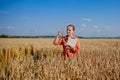 Caucasian Agronomist checking the field of cereals and sends data to the cloud from the tablet. Smart farming and digital