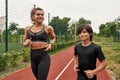 Mother and son jog or run on running track in park Royalty Free Stock Photo