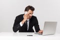 Caucasian attractive businessman worried and tired talking on mobile phone sitting at office desk working in stress Royalty Free Stock Photo