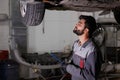 Caucasian auto mechanic writing job checklist to clipboard Royalty Free Stock Photo