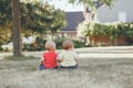 Caucasian babies sitting together in field meadow outside Royalty Free Stock Photo
