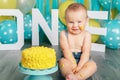 Caucasian baby boy celebrating his first birthday. Cake smash Royalty Free Stock Photo