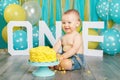 Caucasian baby boy celebrating his first birthday. Cake smash Royalty Free Stock Photo