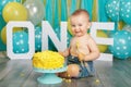 Caucasian baby boy celebrating his first birthday. Cake smash Royalty Free Stock Photo