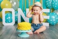 Caucasian baby boy celebrating his first birthday. Cake smash