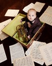 Caucasian baby boy plays with trumpet