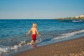 Caucasian baby boy walk on the beach