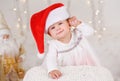 Caucasian baby girl with blue eyes wearing santa claus hat celebrating Christmas or New Year holiday Royalty Free Stock Photo