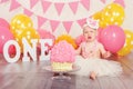Caucasian baby girl in tutu tulle skirt celebrating her first birthday. Cake smash concept Royalty Free Stock Photo