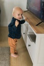 Caucasian baby newborn infant making first steps. Cute toddler kid child son boy learning walking creeping on living Royalty Free Stock Photo