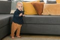 Caucasian baby newborn infant making first steps. Cute toddler kid child son boy learning walking creeping on living Royalty Free Stock Photo