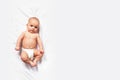 Caucasian baby on white blanket. Top view. Royalty Free Stock Photo