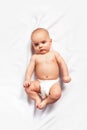 Caucasian baby on white blanket. Top view. Royalty Free Stock Photo