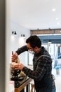 Caucasian baker with mask preparing a cake in a bakery