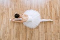 Caucasian ballerina in pointe shoes at white wooden floor background. Royalty Free Stock Photo