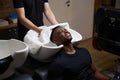 Caucasian barber dries clients hair with a soft towel